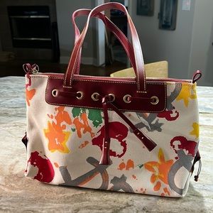 Dooney & Bourke purse new. Includes original registration card.
